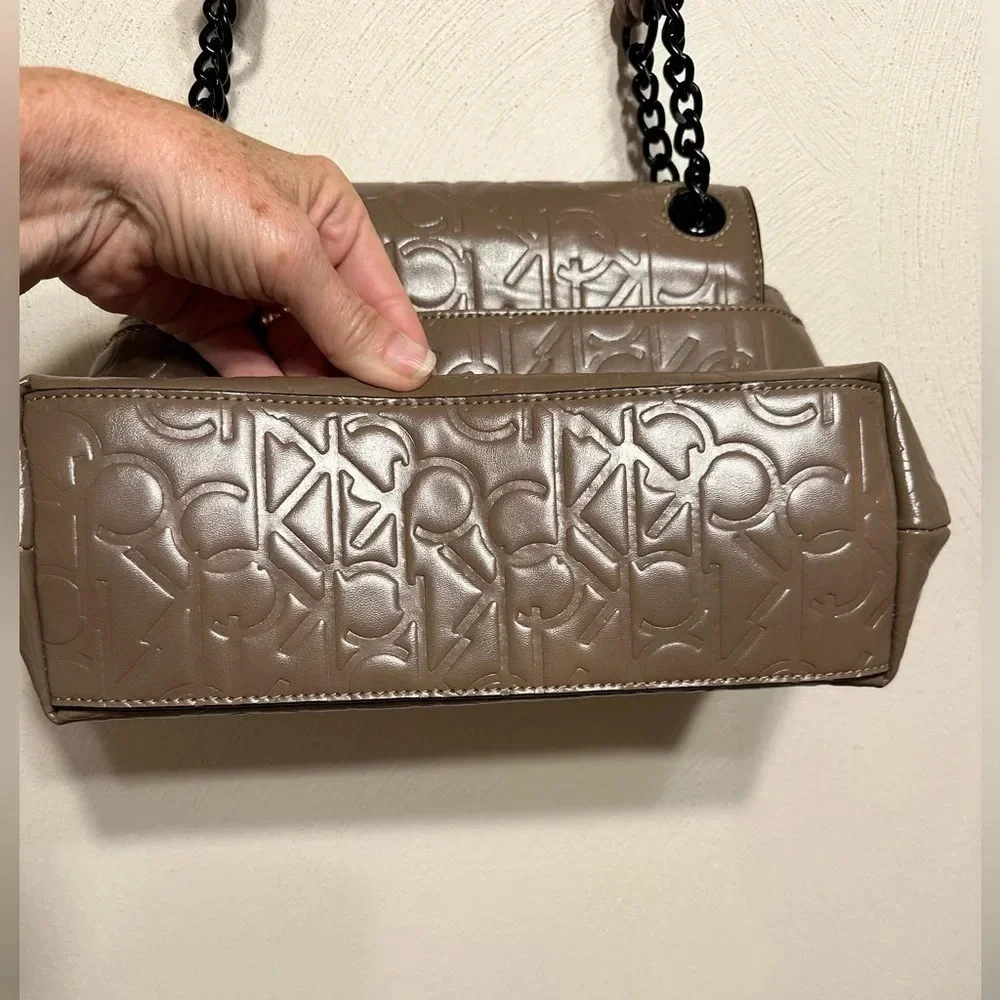 Calvin Klein logo purse. Leather and chain strap. Taupe color, 3 compartments